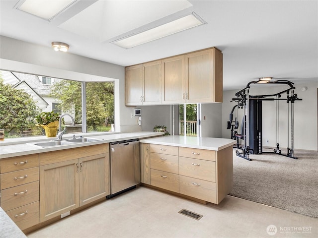 12120 A St S, Tacoma, WA 98444 - kitchen with stainless steel dishwasher, a sink, a peninsula, and light brown cabinets