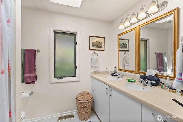 16 Loch Ln SW, Lakewood, WA 98499 - full bath featuring double vanity, a skylight, and tile patterned floors