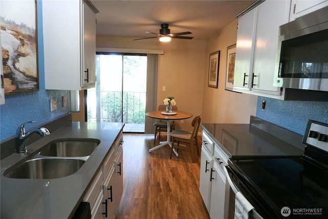 3435 Auburn Way S Unit 15, Auburn, WA 98092 - kitchen with appliances with stainless steel finishes, a sink, a ceiling fan, dark wood-type flooring, and white cabinetry