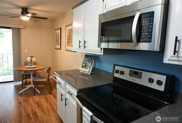 3435 Auburn Way S Unit 15, Auburn, WA 98092 - kitchen featuring stainless steel appliances, wood finished floors, white cabinetry, and ceiling fan