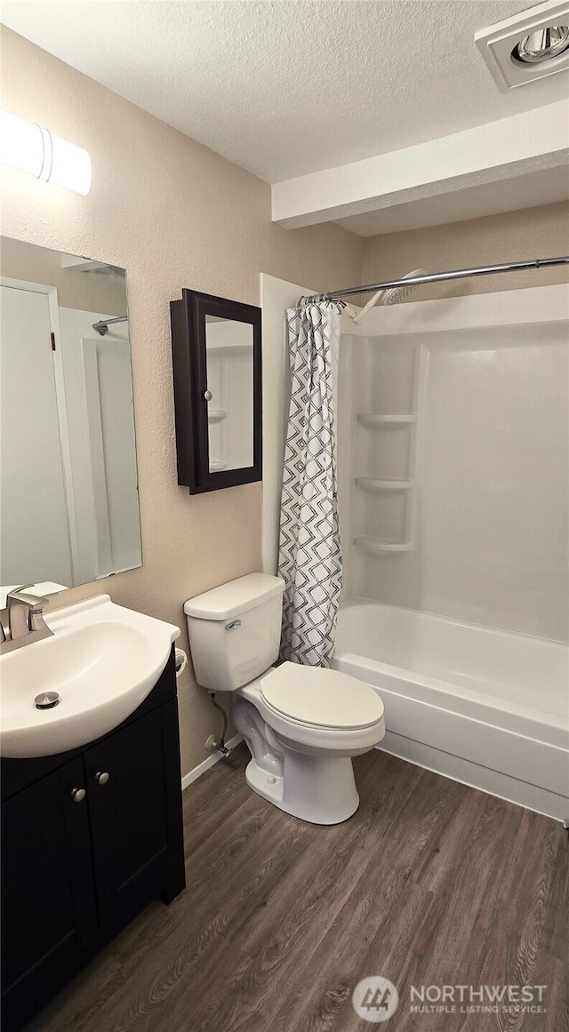 3435 Auburn Way S Unit 15, Auburn, WA 98092 - bathroom with a textured ceiling, wood finished floors, toilet, vanity, and a textured wall