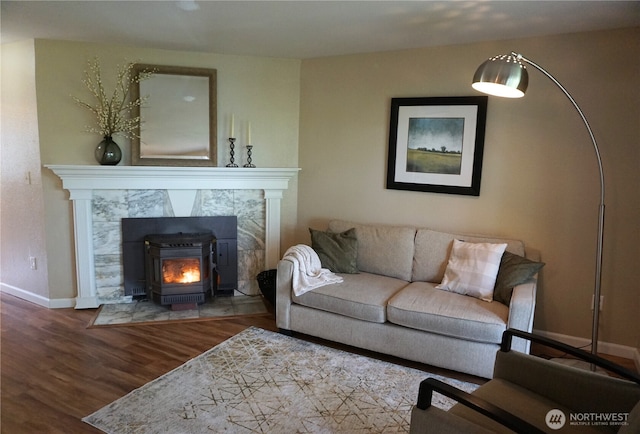 3435 Auburn Way S Unit 15, Auburn, WA 98092 - living room featuring wood finished floors, baseboards, and a wood stove