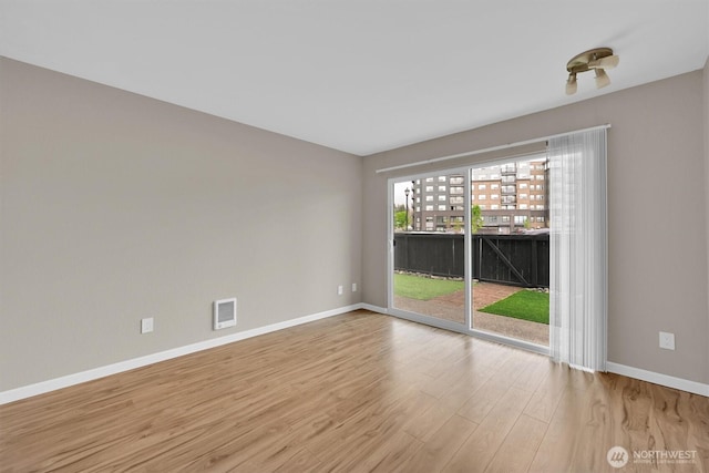1175 Harrington Pl NE Unit 101, Renton, WA 98056 - spare room with wood finished floors and baseboards