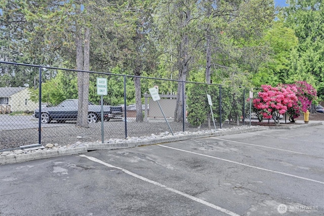 1175 Harrington Pl NE Unit 101, Renton, WA 98056 - uncovered parking lot featuring fence