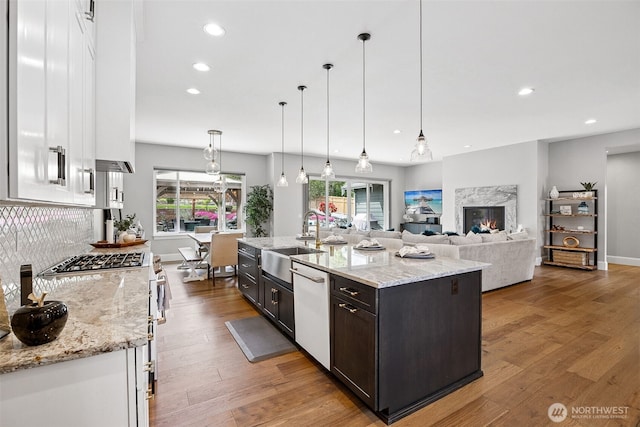 9402 72nd Ave E, Puyallup, WA 98371 - kitchen with a sink, stainless steel stove, dishwasher, light wood-style flooring, and recessed lighting