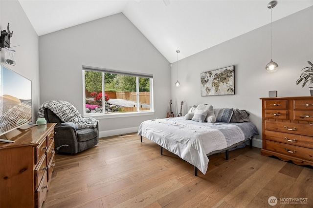 9402 72nd Ave E, Puyallup, WA 98371 - bedroom featuring wood-type flooring, high vaulted ceiling, and baseboards
