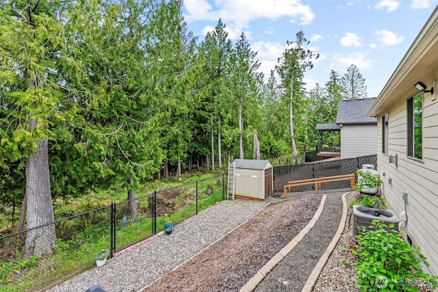 fenced backyard with a shed, central AC unit, and an outbuilding