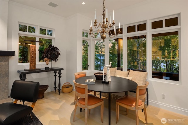 10208 47th Ave SW, Seattle, WA 98146 - dining area with plenty of natural light, a chandelier, crown molding, and baseboards