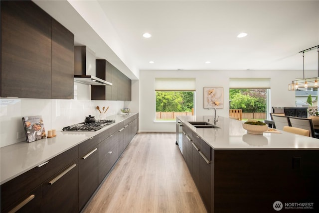 12421 Harwood Cove Ln SW, Lakewood, WA 98498 - kitchen with a sink, wall chimney range hood, modern cabinets, stainless steel appliances, and recessed lighting