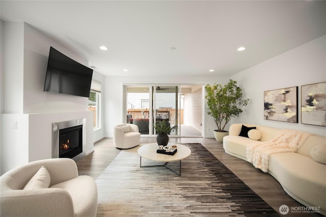12421 Harwood Cove Ln SW, Lakewood, WA 98498 - living room featuring wood finished floors, recessed lighting, and a glass covered fireplace