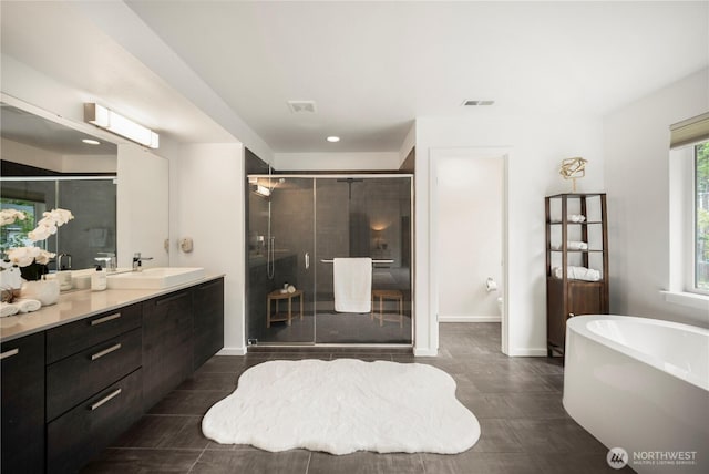 12421 Harwood Cove Ln SW, Lakewood, WA 98498 - full bathroom featuring a shower stall, vanity, a freestanding tub, recessed lighting, and baseboards