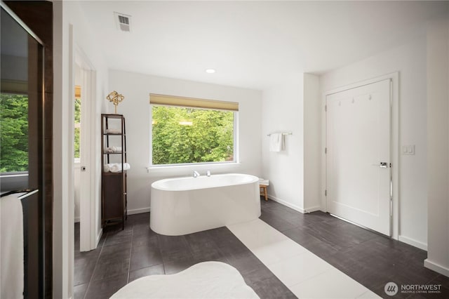 12421 Harwood Cove Ln SW, Lakewood, WA 98498 - bathroom featuring a freestanding bath, recessed lighting, baseboards, and tile patterned flooring
