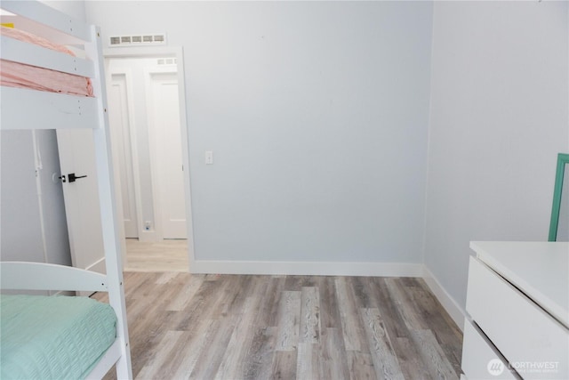 21833 127th Ave SE, Snohomish, WA 98296 - unfurnished bedroom featuring light wood finished floors and baseboards