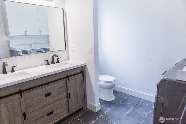 21833 127th Ave SE, Snohomish, WA 98296 - bathroom with double vanity, toilet, baseboards, and tile patterned flooring