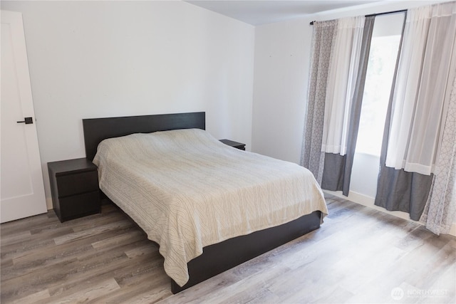 21833 127th Ave SE, Snohomish, WA 98296 - bedroom featuring wood finished floors and multiple windows