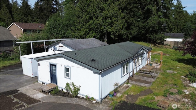 21833 127th Ave SE, Snohomish, WA 98296 - view of side of property featuring roof with shingles and a lawn