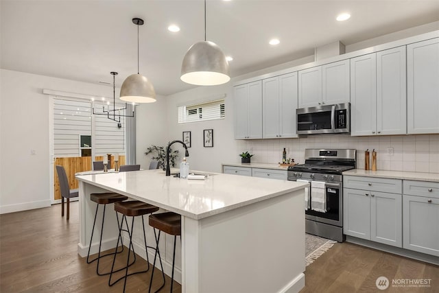 8008 222nd St SW, Edmonds, WA 98026 - kitchen featuring appliances with stainless steel finishes, a sink, decorative backsplash, dark wood-style flooring, and recessed lighting
