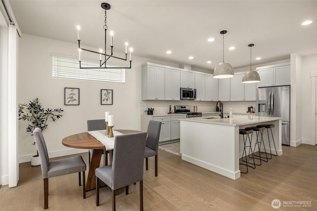 8008 222nd St SW, Edmonds, WA 98026 - dining room featuring a chandelier, recessed lighting, light wood finished floors, and baseboards