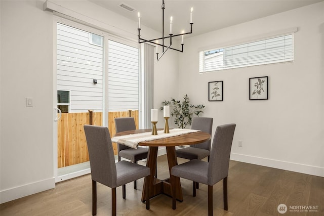 8008 222nd St SW, Edmonds, WA 98026 - dining room featuring a chandelier, baseboards, and wood finished floors