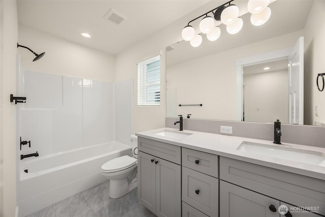 8008 222nd St SW, Edmonds, WA 98026 - full bath with toilet, marble look tiles, double vanity, recessed lighting, and shower / bathtub combination