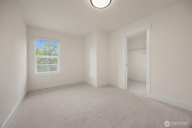 8008 222nd St SW, Edmonds, WA 98026 - unfurnished bedroom with light carpet, baseboards, a closet, and a walk in closet