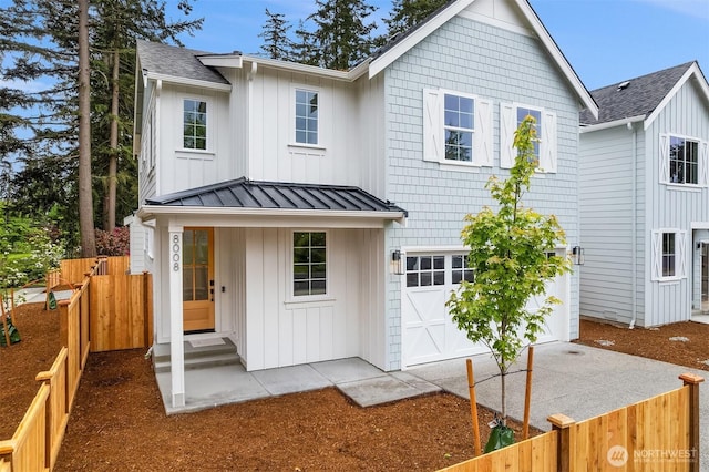 8008 222nd St SW, Edmonds, WA 98026 - view of front facade featuring a garage, board and batten siding, a standing seam roof, roof with shingles, and metal roof