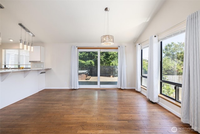 87 Swinomish Dr, La Conner, WA 98257 - unfurnished dining area with dark wood-style flooring, plenty of natural light, and baseboards