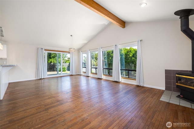87 Swinomish Dr, La Conner, WA 98257 - unfurnished living room with a wood stove, hardwood / wood-style flooring, and baseboards