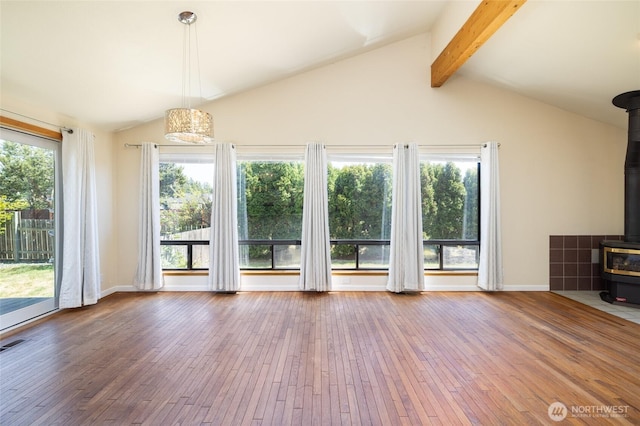 87 Swinomish Dr, La Conner, WA 98257 - unfurnished living room with a wood stove, wood-type flooring, and baseboards