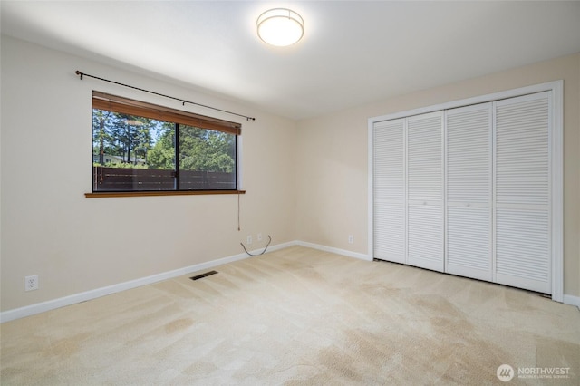 87 Swinomish Dr, La Conner, WA 98257 - unfurnished bedroom featuring carpet flooring, baseboards, and a closet