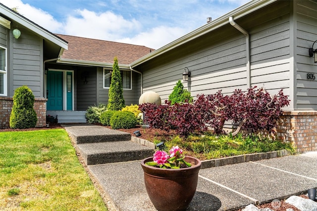805 E Pacificview Dr, Bellingham, WA 98229 - property entrance featuring roof with shingles, uncovered parking, and brick siding