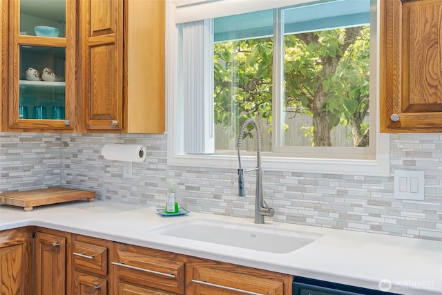 805 E Pacificview Dr, Bellingham, WA 98229 - kitchen featuring a sink, decorative backsplash, glass insert cabinets, and light countertops