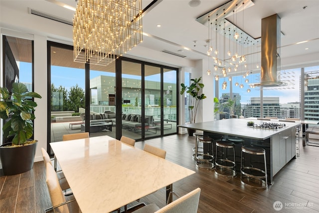1808 Minor Ave Unit 301, Seattle, WA 98101 - dining room featuring a chandelier, plenty of natural light, wood finished floors, a city view, and expansive windows