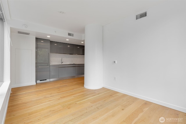 1808 Minor Ave Unit 301, Seattle, WA 98101 - spare room featuring light wood-style floors, a sink, recessed lighting, and baseboards