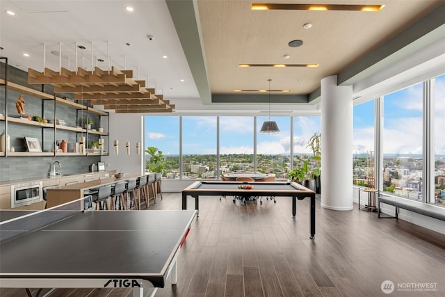 1808 Minor Ave Unit 301, Seattle, WA 98101 - playroom featuring healthy amount of natural light, dark wood-style flooring, recessed lighting, and wet bar