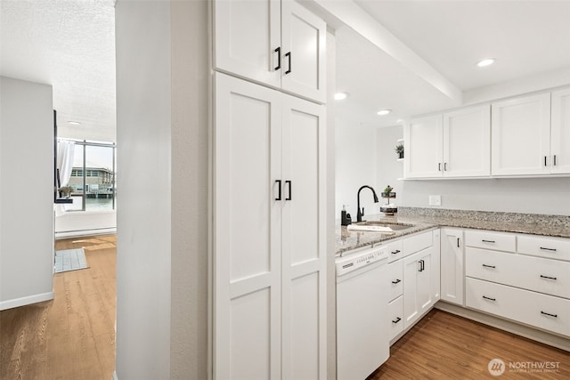 7 Lake Bellevue Dr Unit 109, Bellevue, WA 98005 - kitchen with a sink, white dishwasher, wood finished floors, white cabinetry, and recessed lighting