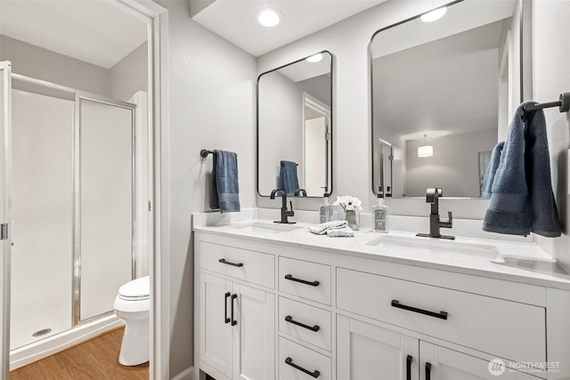 7 Lake Bellevue Dr Unit 109, Bellevue, WA 98005 - full bath featuring a stall shower, double vanity, toilet, and wood finished floors