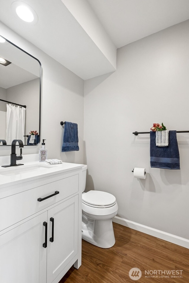 7 Lake Bellevue Dr Unit 109, Bellevue, WA 98005 - bathroom featuring toilet, wood finished floors, vanity, and baseboards