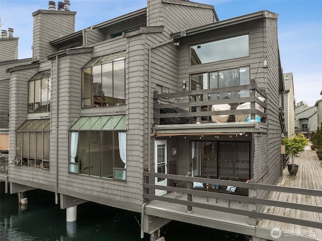 7 Lake Bellevue Dr Unit 109, Bellevue, WA 98005 - back of property featuring a balcony, a chimney, and a deck with water view