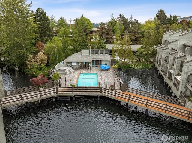 7 Lake Bellevue Dr Unit 109, Bellevue, WA 98005 - dock area featuring a water view, an outdoor pool, and view of scattered trees