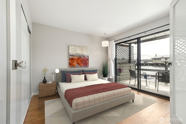7 Lake Bellevue Dr Unit 109, Bellevue, WA 98005 - bedroom featuring access to outside, wood finished floors, and baseboards