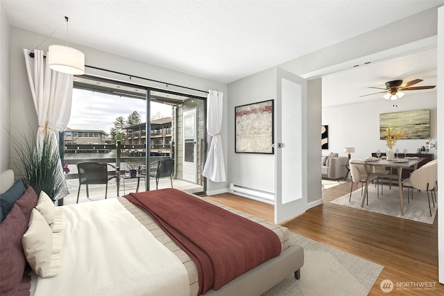 7 Lake Bellevue Dr Unit 109, Bellevue, WA 98005 - bedroom with a baseboard heating unit, access to exterior, wood finished floors, and baseboards