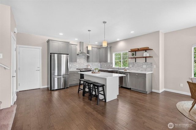 704 Springside Ln, Bellingham, WA 98226 - kitchen featuring stainless steel appliances, gray cabinets, wall chimney exhaust hood, a breakfast bar, and recessed lighting