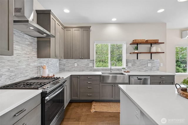 704 Springside Ln, Bellingham, WA 98226 - kitchen featuring appliances with stainless steel finishes, wall chimney range hood, dark wood finished floors, light countertops, and gray cabinetry