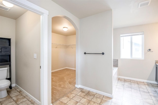 18509 11th Ln E, Spanaway, WA 98387 - full bathroom with toilet, a garden tub, and baseboards