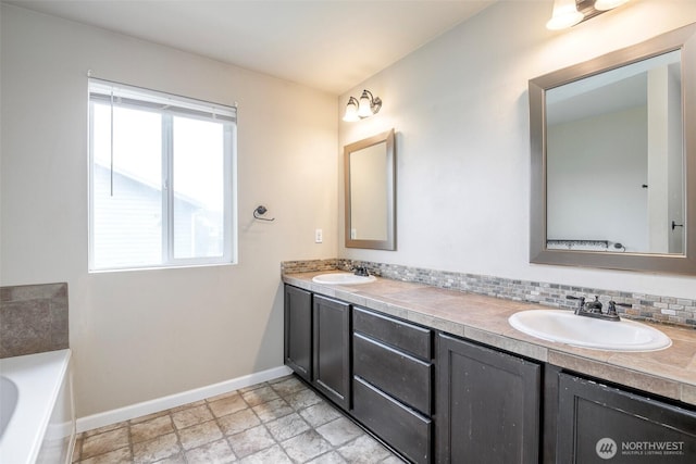 18509 11th Ln E, Spanaway, WA 98387 - full bath featuring baseboards, double vanity, a tub, and stone finish flooring