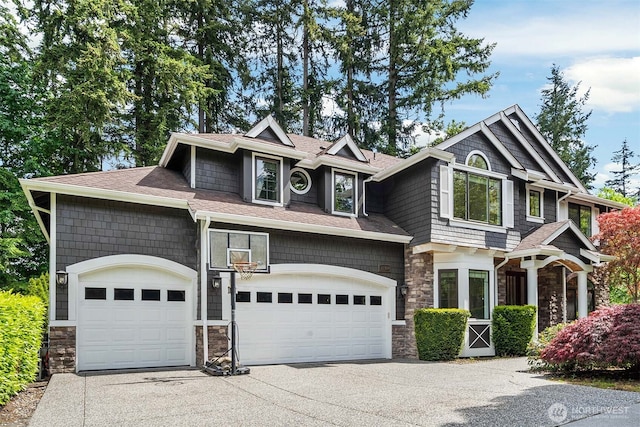 22309 1st Dr SE, Bothell, WA 98021 - craftsman-style home with stone siding, concrete driveway, an attached garage, and roof with shingles