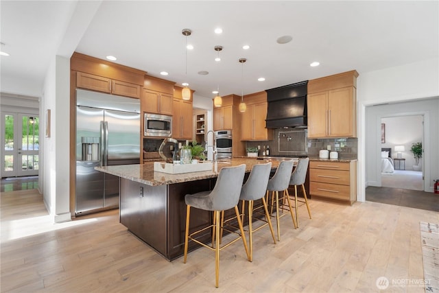 22309 1st Dr SE, Bothell, WA 98021 - kitchen with custom exhaust hood, built in appliances, light wood-style flooring, backsplash, and recessed lighting