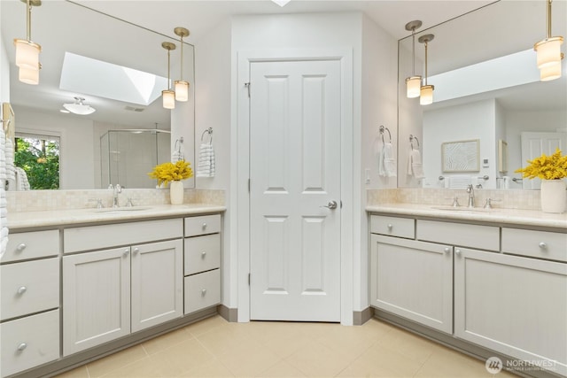 22309 1st Dr SE, Bothell, WA 98021 - full bathroom featuring a skylight, a stall shower, two vanities, and tile patterned floors