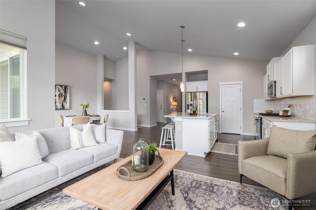 living room with recessed lighting, baseboards, dark wood-style flooring, and high vaulted ceiling